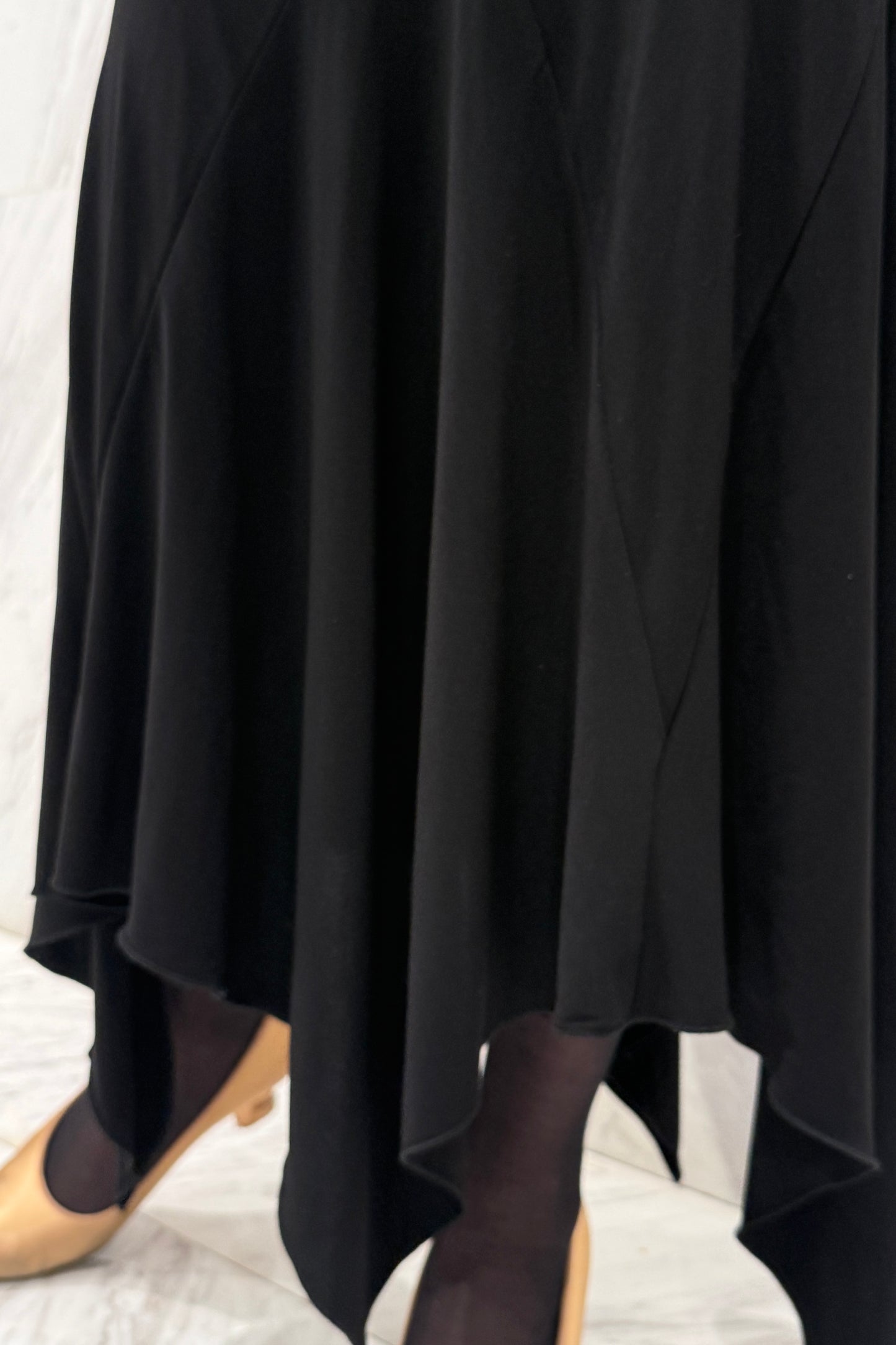 Black biflex ballroom dress with voluminous sleeves and an asymmetrical skirt